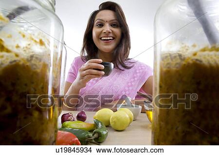 Portrait of a woman holding a bowl View Large Photo Image Picture - Portrait of a woman holding a bowl . Fotosearch
