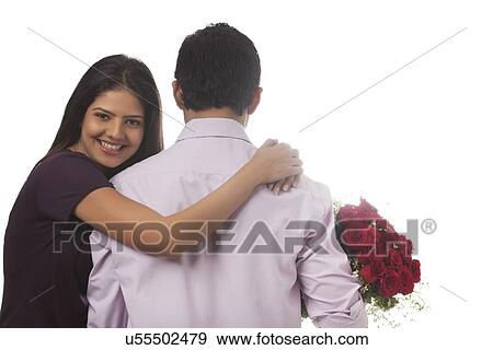 Portrait of a woman holding a man with a bouquet of roses View Large Photo Image Stock Photo - Portrait of a woman holding a man with a bouquet of roses. Fotosearch