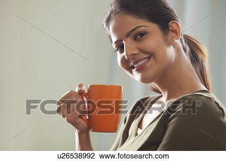 Portrait of a woman holding a mug of tea View Large Photo Image Stock Image - Portrait of a woman holding a mug of tea. Fotosearch