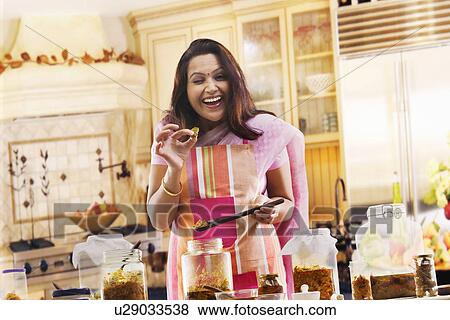 Portrait of a woman holding a pickle View Large Photo Image Stock Photo - Portrait of a woman holding a pickle . Fotosearch