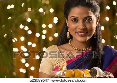 Stock Photo - Portrait of a woman holding a tray . Fotosearch
