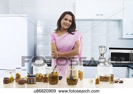 Portrait of a woman standing in the kitchen View Large Photo Image Stock Photo - Portrait of a woman standing in the kitchen . Fotosearch