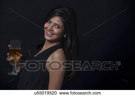 Portrait of a woman with a glass of wine smiling View Large Photo Image Stock Image - Portrait of a woman with a glass of wine smiling. Fotosearch