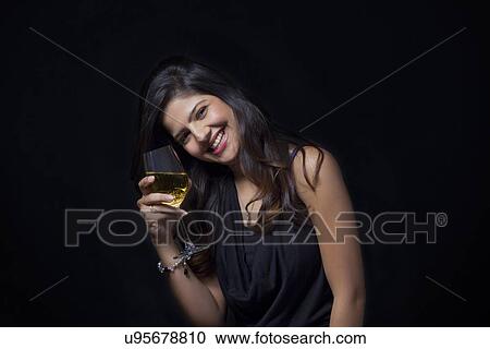 Portrait of a woman with a glass of wine smiling View Large Photo Image Stock Image - Portrait of a woman with a glass of wine smiling. Fotosearch