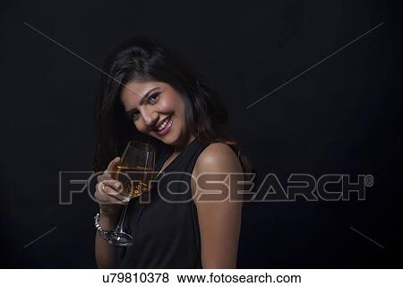 Stock Photo - Portrait of a woman with a glass of wine smiling. Fotosearch