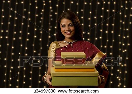 Stock Image - Portrait of a woman with gifts . Fotosearch