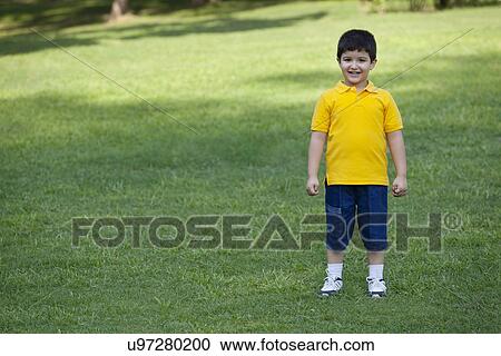 Portrait of a young boy in a park View Large Photo Image Stock Image - Portrait of a young boy in a park. Fotosearch