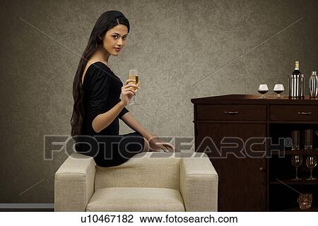 Portrait of a young woman with a glass of wine View Large Photo Image Stock Image - Portrait of a young woman with a glass of wine . Fotosearch