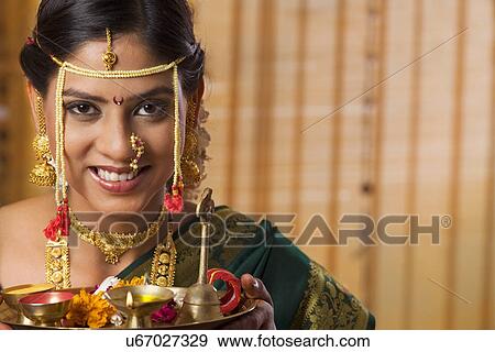 Stock Photo - Portrait of beautiful Maharashtrian bride with offerings . Fotosearch
