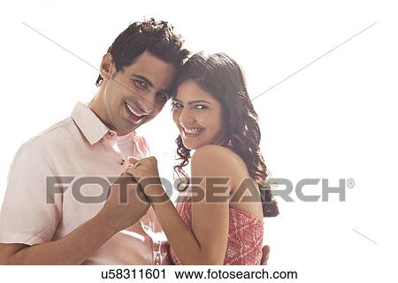 Stock Image - Portrait of couple holding each other. Fotosearch