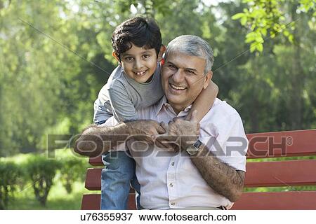 Portrait of grandfather and grandson hugging in a park View Large Photo Image Stock Photo - Portrait of grandfather and grandson hugging in a park. Fotosearch