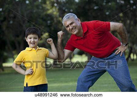 Portrait of grandfather and grandson flexing their muscles View Large Photo Image Stock Photograph - Portrait of grandfather and grandson flexing their muscles. Fotosearch