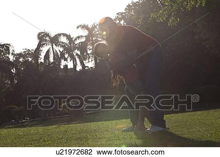 Portrait of grandfather and granddaughter hugging in a park View Large Photo Image Stock Image - Portrait of grandfather and granddaughter hugging in a park. Fotosearch