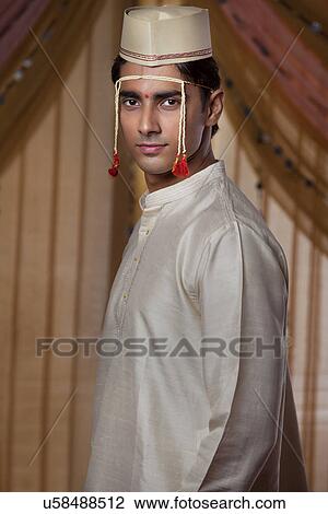 Portrait of handsome Indian groom looking at you View Large Photo Image Stock Image - Portrait of handsome Indian groom looking at you . Fotosearch