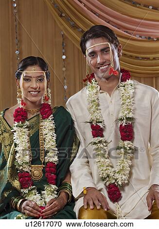 Stock Image - Portrait of just married Maharashtrian couple smiling together . Fotosearch