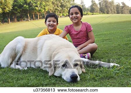 Portrait of kids sitting with their dog View Large Photo Image Stock Image - Portrait of kids sitting with their dog. Fotosearch