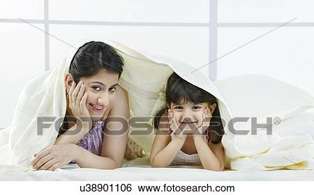 Portrait of mother and daughter under a bed sheet View Large Photo Image Stock Photograph - Portrait of mother and daughter under a bed sheet . Fotosearch
