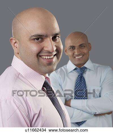 Portrait of two bald executives View Large Photo Image Picture - Portrait of two bald executives . Fotosearch