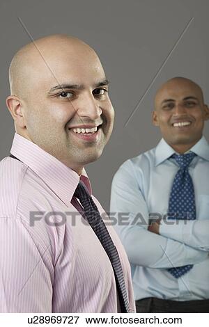 Stock Photo - Portrait of two bald executives . Fotosearch
