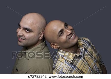 Stock Image - Portrait of two bald men . Fotosearch