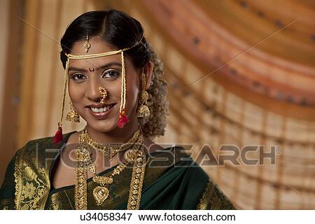 Portrait of young bride dressed up in Marathi style View Large Photo Image Stock Photo - Portrait of young bride dressed up in Marathi style . Fotosearch