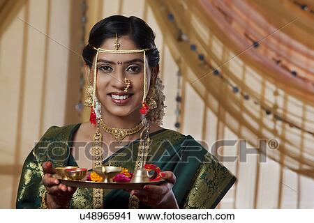 Portrait of young bride holding offerings View Large Photo Image Stock Image - Portrait of young bride holding offerings . Fotosearch