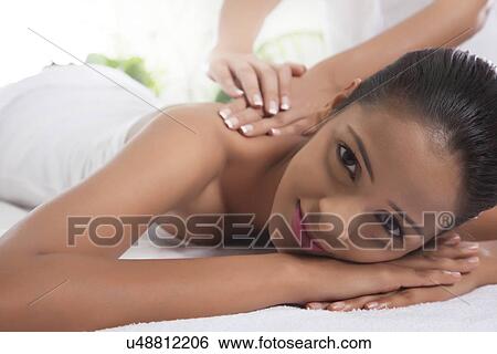 Portrait of young woman receiving back massage View Large Photo Image Stock Photograph - Portrait of young woman receiving back massage . Fotosearch