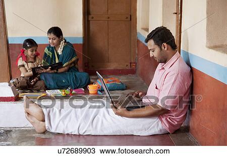 Rural man working on his laptop View Large Photo Image Stock Image - Rural man working on his laptop . Fotosearch