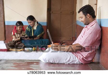 Rural man working on his laptop View Large Photo Image Stock Image - Rural man working on his laptop . Fotosearch