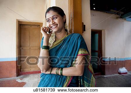 Stock Photo - Rural woman talking on a mobile phone . Fotosearch