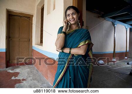Rural woman talking on a mobile phone View Large Photo Image Stock Photo - Rural woman talking on a mobile phone . Fotosearch