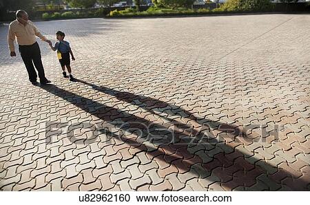 School boy holding his grandfathers hand View Large Photo Image Stock Image - School boy holding his grandfathers hand . Fotosearch