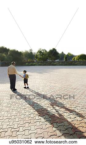 School boy holding his grandfathers hand View Large Photo Image Stock Image - School boy holding his grandfathers hand . Fotosearch