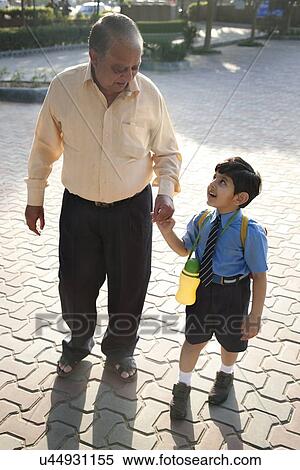 School boy holding his grandfathers hand View Large Photo Image Stock Photography - School boy holding his grandfathers hand . Fotosearch