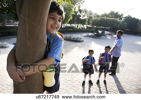 School boy hugging a tree View Large Photo Image Stock Photo - School boy hugging a tree . Fotosearch