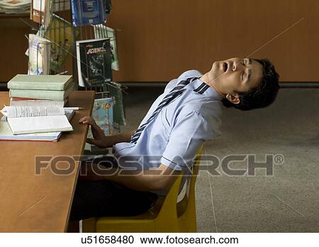 School boy sleeping on a chair View Large Photo Image Stock Image - School boy sleeping on a chair . Fotosearch