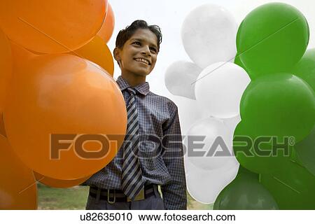 Stock Image - School boy with colored balloons . Fotosearch