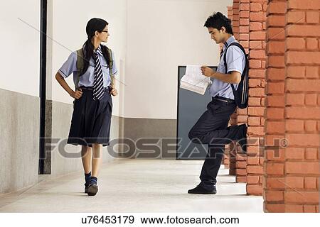 School girl looking at a school boy View Large Photo Image Stock Photo - School girl looking at a school boy . Fotosearch