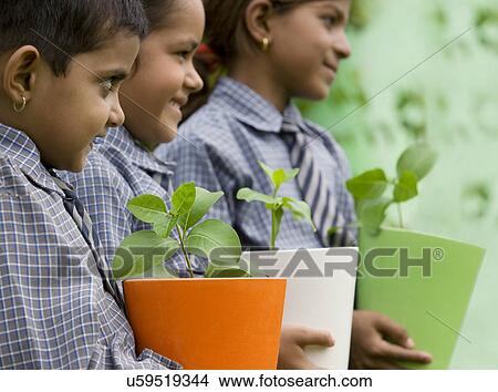 School girls holding potted plants View Large Photo Image Picture - School girls holding potted plants . Fotosearch