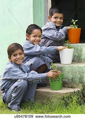 School kids with colored potted plants View Large Photo Image Stock Photo - School kids with colored potted plants . Fotosearch