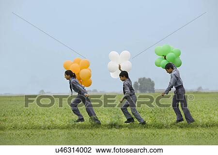 School students holding colored balloons View Large Photo Image Stock Image - School students holding colored balloons . Fotosearch