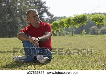 Senior man sitting in a park View Large Photo Image Stock Photography - Senior man sitting in a park. Fotosearch