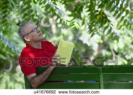Senior man with a book thinking View Large Photo Image Stock Image - Senior man with a book thinking. Fotosearch