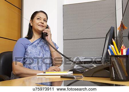 Senior woman executive talking on a phone View Large Photo Image Stock Image - Senior woman executive talking on a phone. Fotosearch