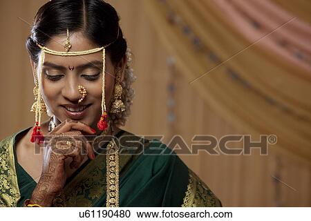 Stock Image - Shy young Maharashtrian bride looking down . Fotosearch
