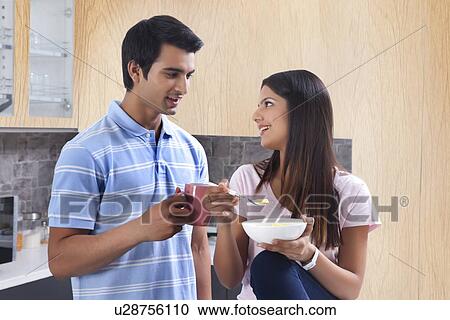 Smiling couple having coffee and pasta in kitchen View Large Photo Image Stock Image - Smiling couple having coffee and pasta in kitchen. Fotosearch