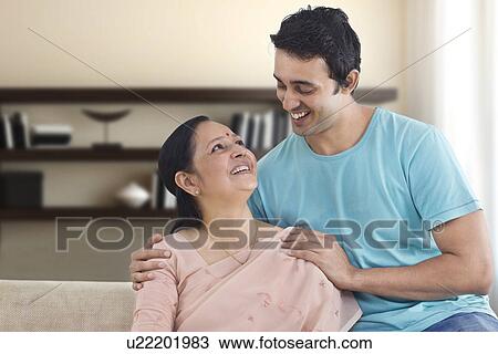 Smiling mother and son looking at each other View Large Photo Image Stock Image - Smiling mother and son looking at each other . Fotosearch