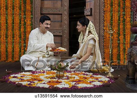 South Indian couple with a flower rangoli View Large Photo Image Picture - South Indian couple with a flower rangoli . Fotosearch