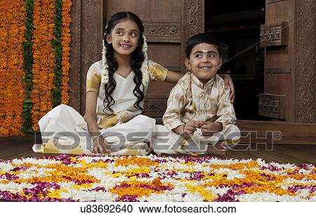 Stock Image - South Indian girl sitting with her brother . Fotosearch
