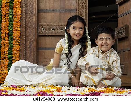Stock Photo - South Indian girl sitting with her brother . Fotosearch